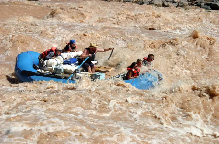 A raft crashing through the huge brown waves of Lava Falls